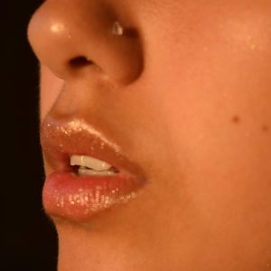 a close up of a woman's lips with a black background